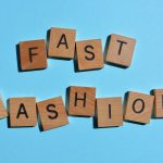 Fast Fashion, words in 3d wooden alphabet letters isolated on colourful background